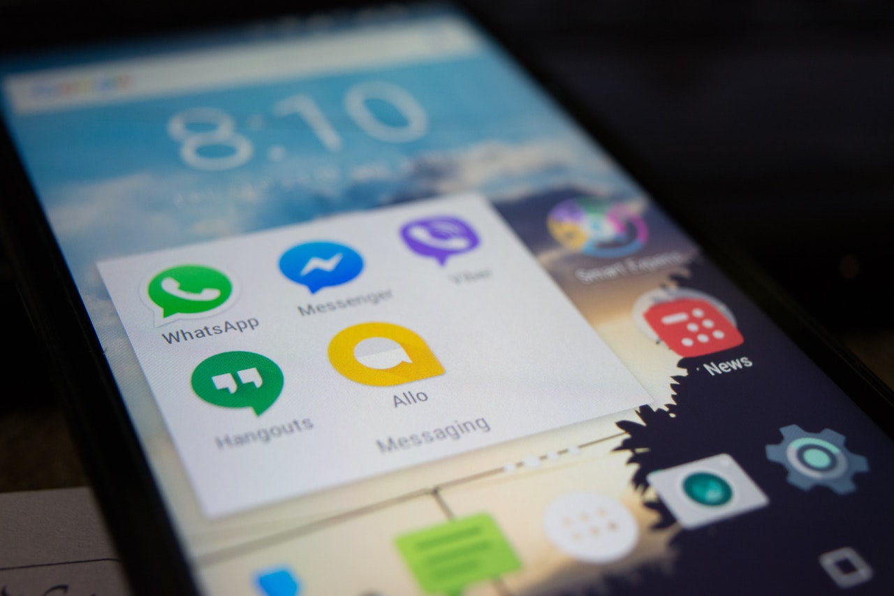 Smartphone screen displaying messaging apps including WhatsApp, Messenger, Hangouts, and Allo, relevant to hearing aid technology and smartphone integration in hearing health.